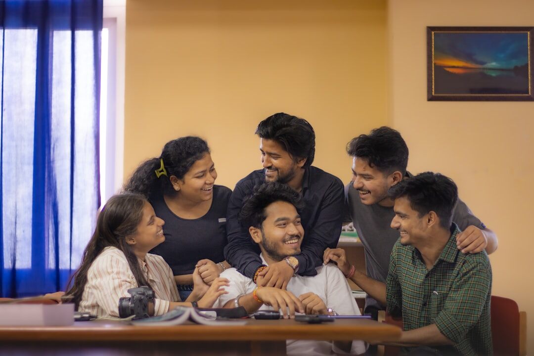 Small team meeting around a table discussing a news project
