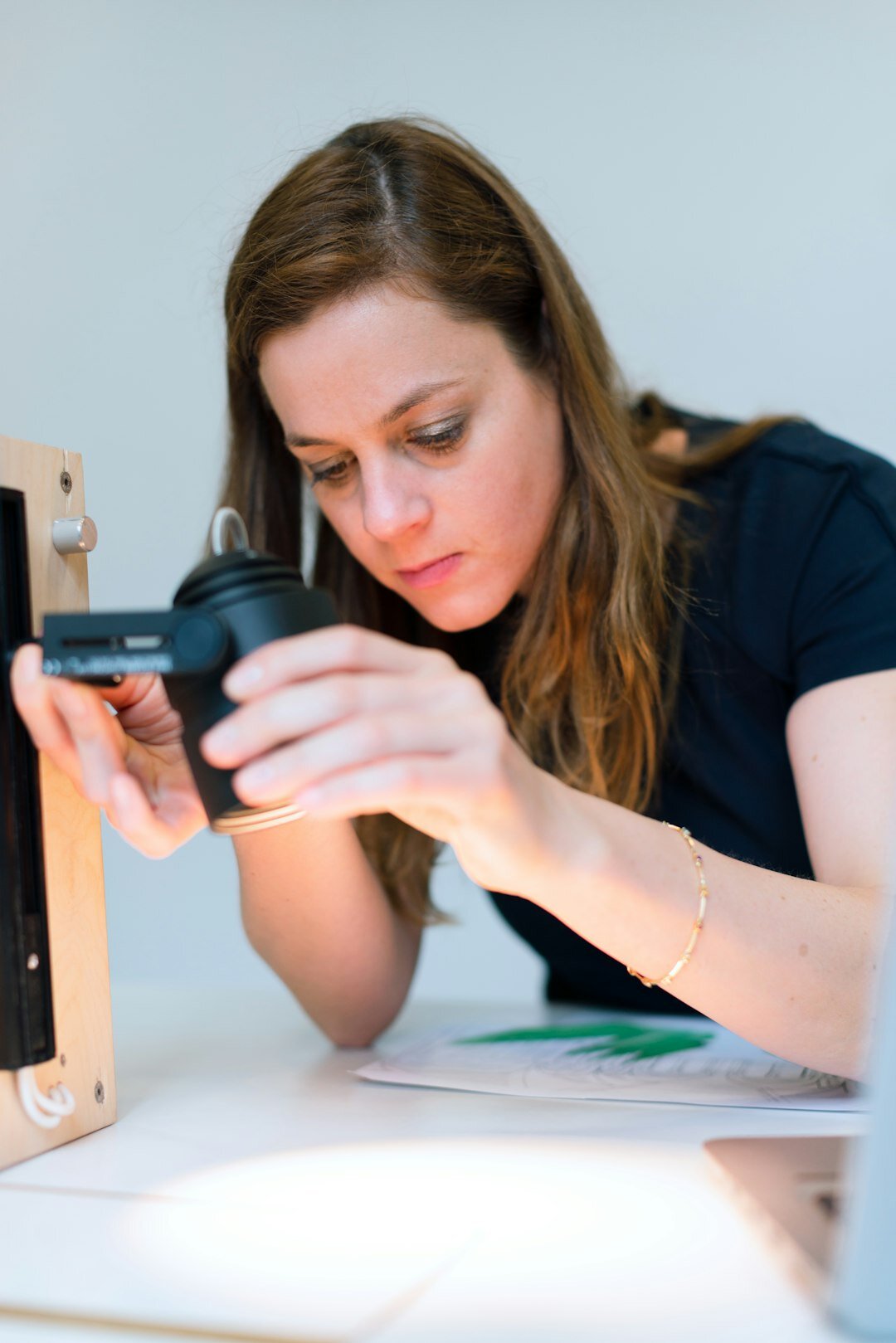 Editor comparing photographs on a light table for a news story